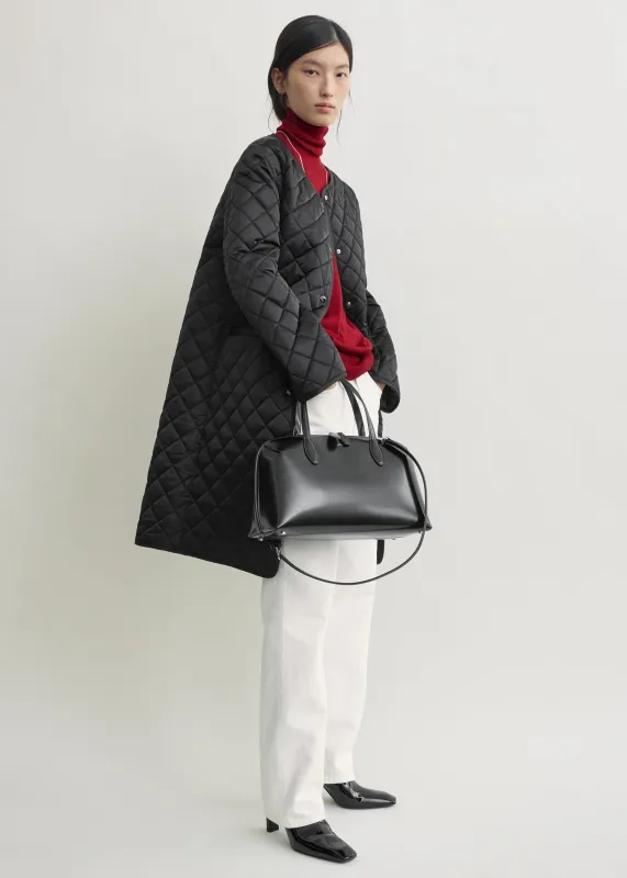 Quilted collarless coat black made by Toteme