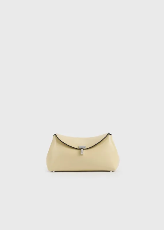 Mini T-lock leather clutch champagne made by Toteme