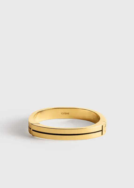 Signature stripe bracelet black/gold made by Toteme