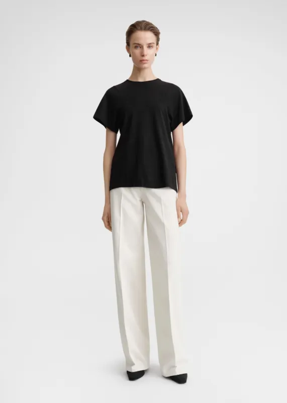 Curved seam tee black sold by Toteme