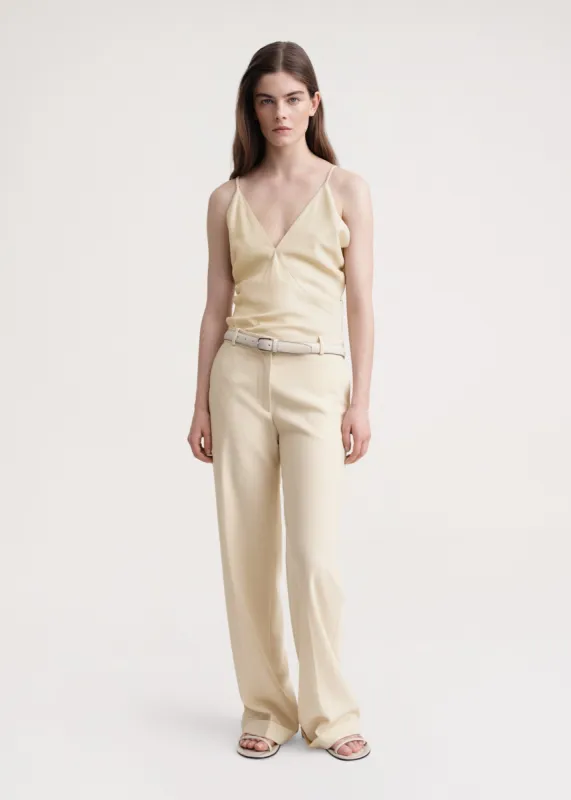 Tailored herringbone suit trouser bleached sand sold by Toteme