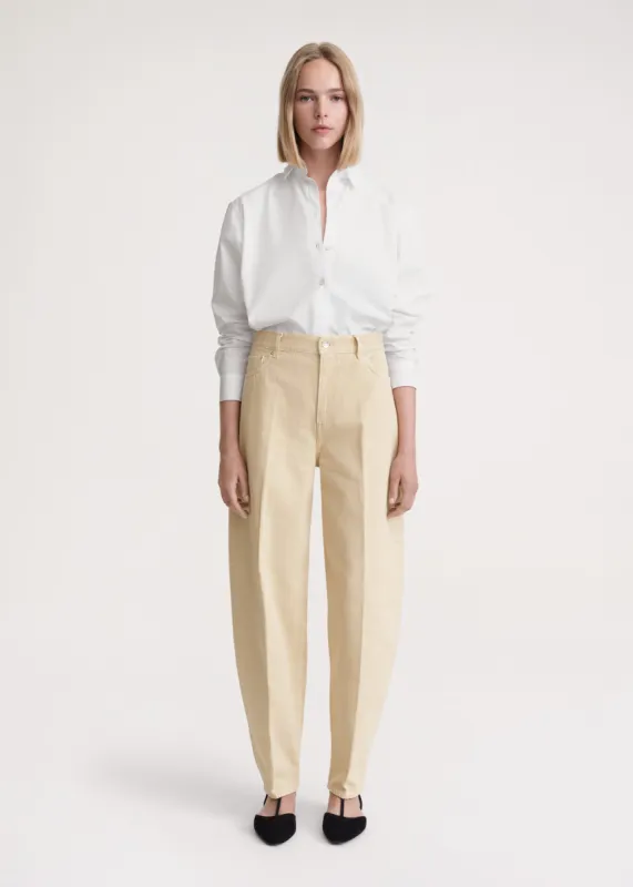 Wide tapered leg denim washed beige sold by Toteme