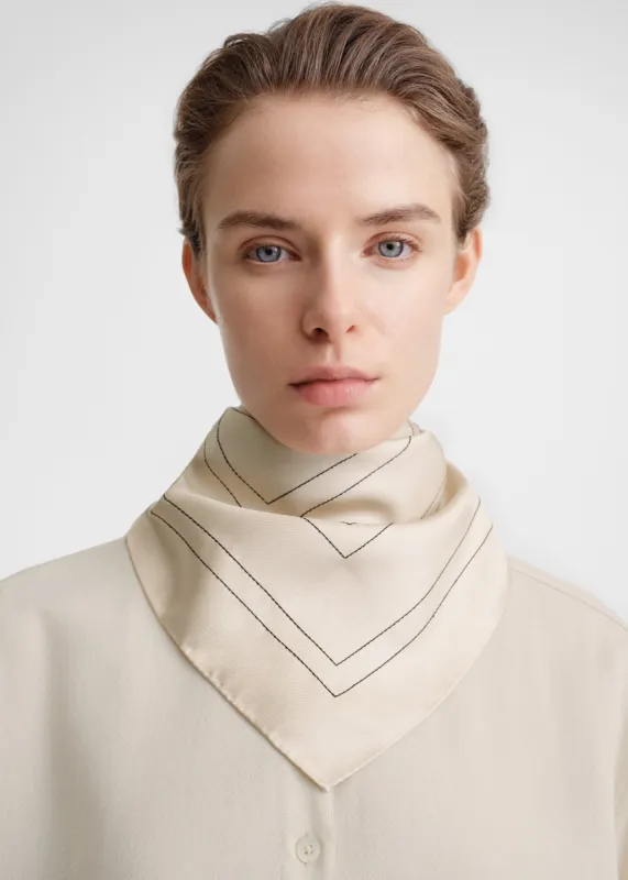 Embroidered monogram silk scarf creme sold by Toteme