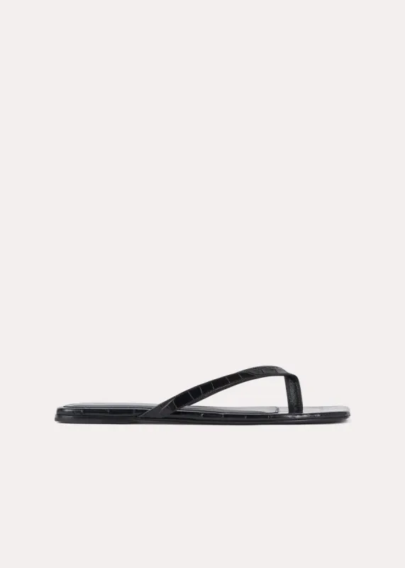 Croco-embossed flip flops black sold by Toteme