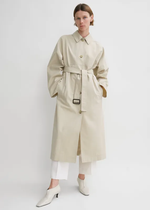 Tumbled cotton silk trench sand sold by Toteme