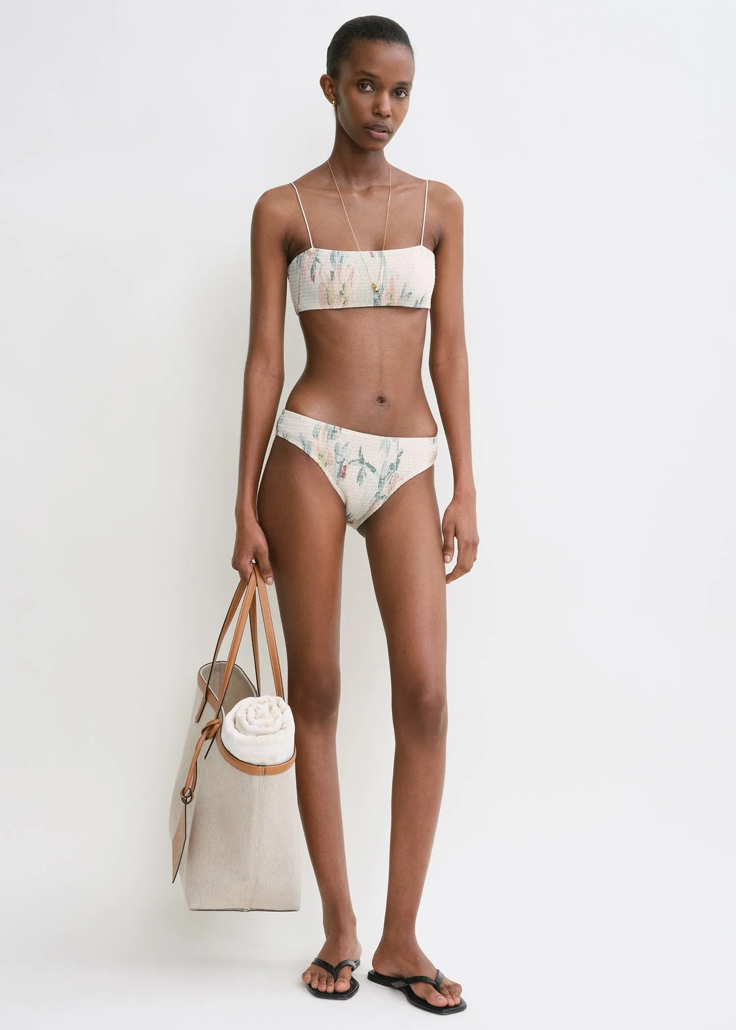 Smocked bikini top washed floral sold by Toteme