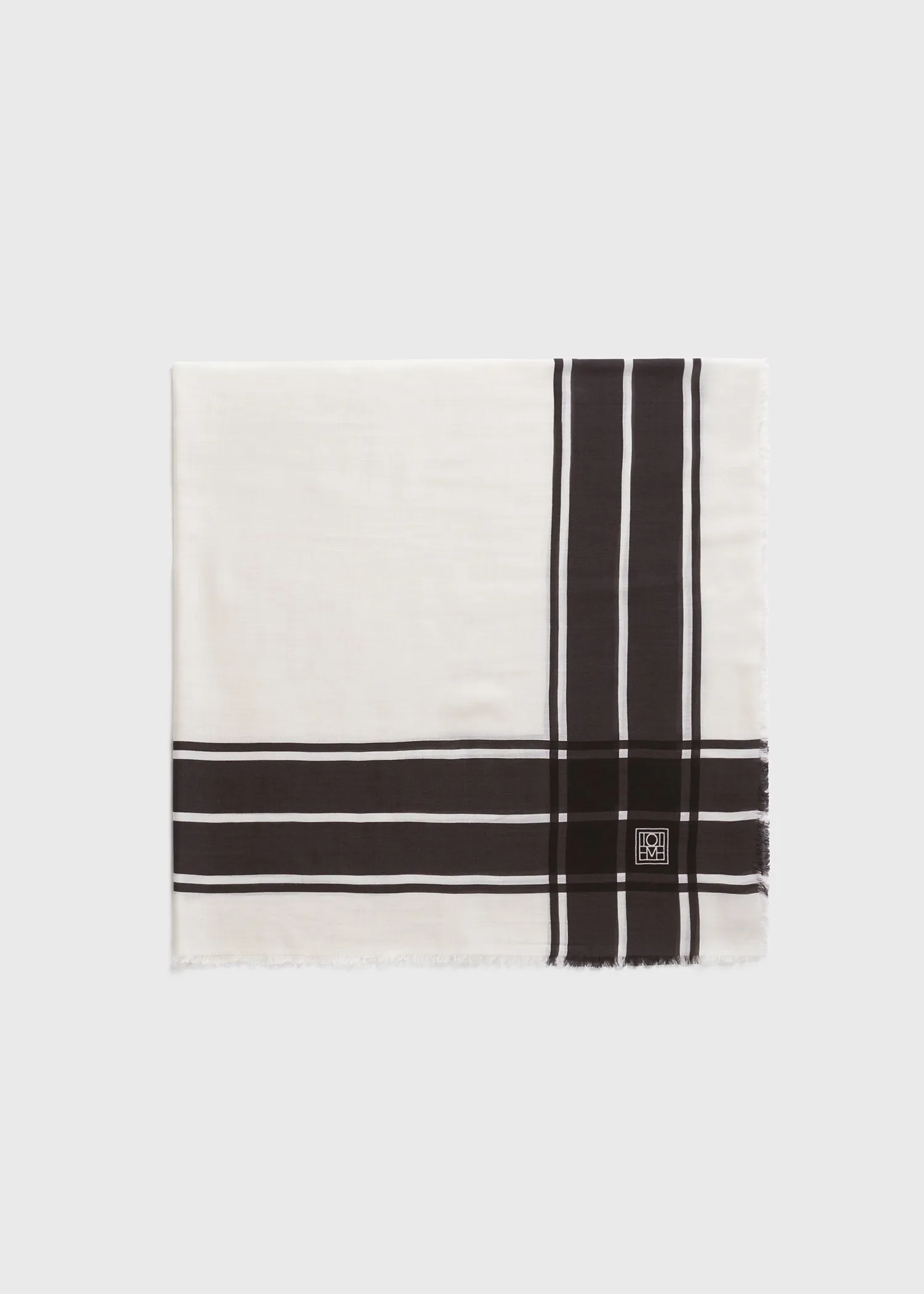 Wool silk blanket scarf black/ecru sold by Toteme