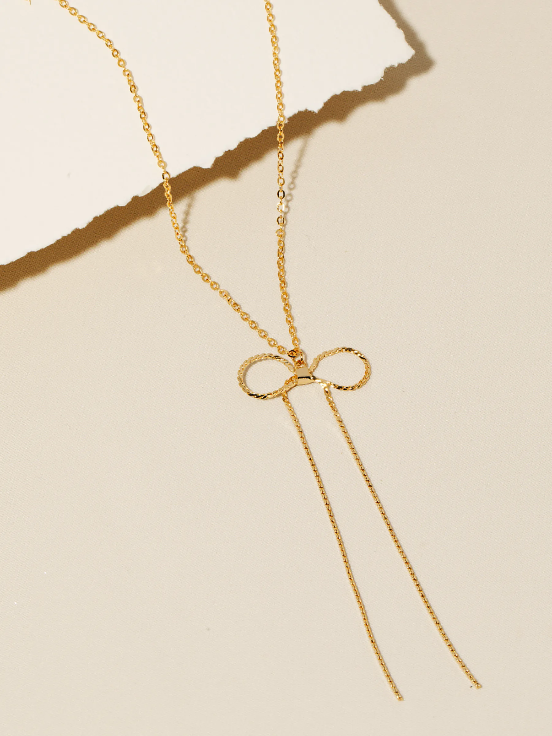 Chain Ribbon Bow Necklace sold by Plenty