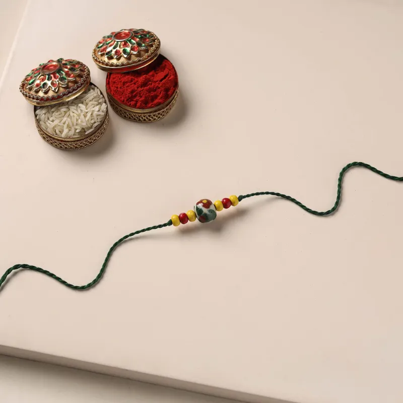 Multicolor - Handmade Blue Pottery & GS Bead Work Rakhi with Potli 11 made by Itokri