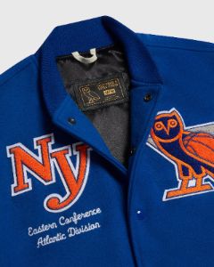 NBA NEW YORK KNICKS VARSITY JACKET - BLUE sold by OVO