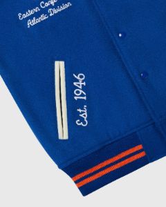 NBA NEW YORK KNICKS VARSITY JACKET - BLUE sold by OVO