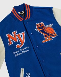 NBA NEW YORK KNICKS VARSITY JACKET - BLUE sold by OVO