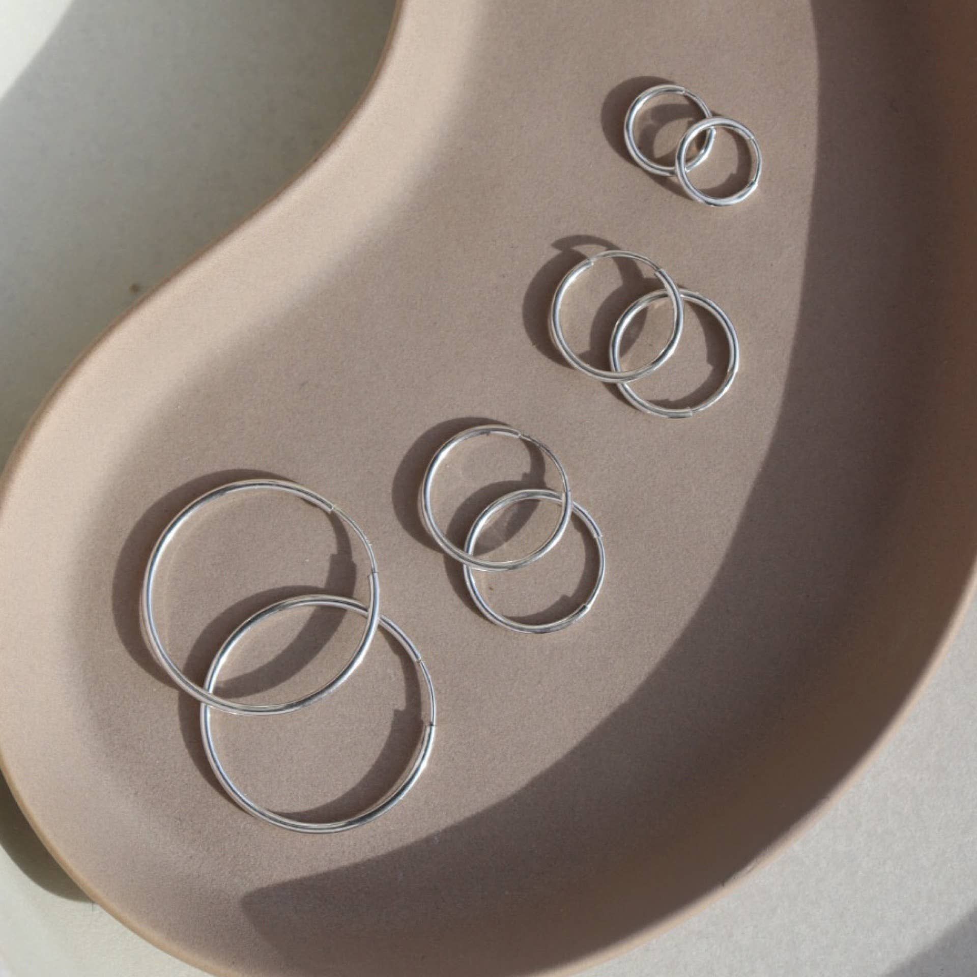 Token Jewelry | Goldie Hoops - Sterling Silver / 24mm sold by Fort