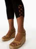 Cross Detail Capris sold by Laura