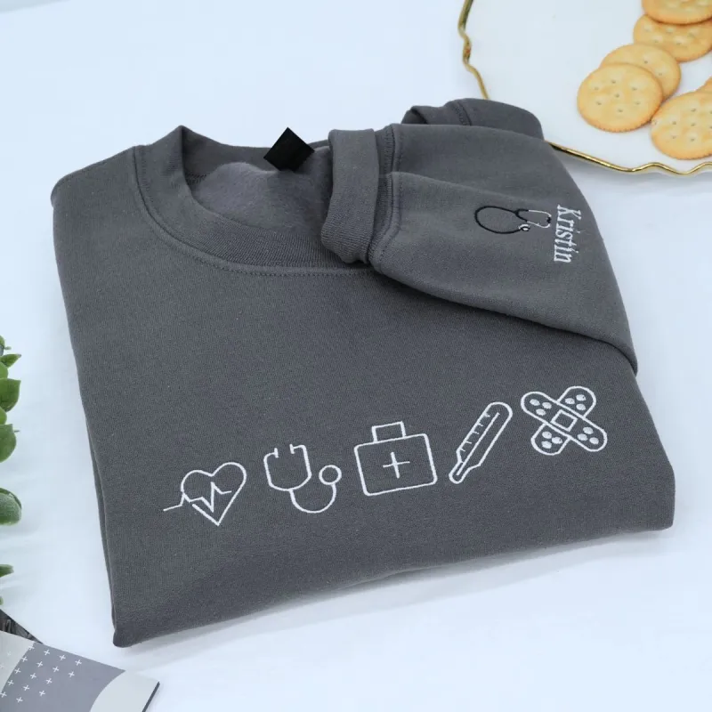 Custom Embroidered Nurse Icon Sweatshirt with Name on Sleeve, Unique Gift For Nurses sold by Embroly