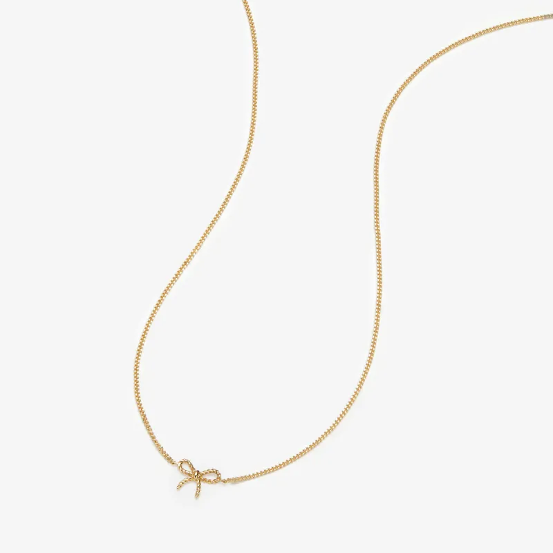 Atticus micro bow necklace sold by Adornmonde