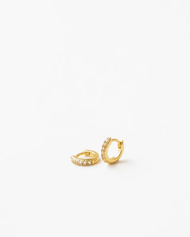 Ona White Sapphire Huggie Hoops sold by GLDN