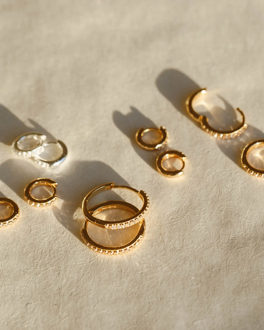 Ona White Sapphire Huggie Hoops sold by GLDN product image thumbnail 3