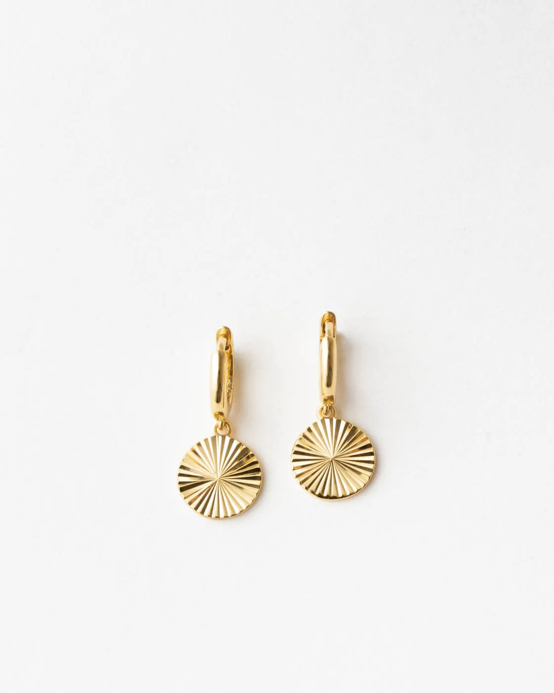 Radiant Charm Huggie Hoops sold by GLDN