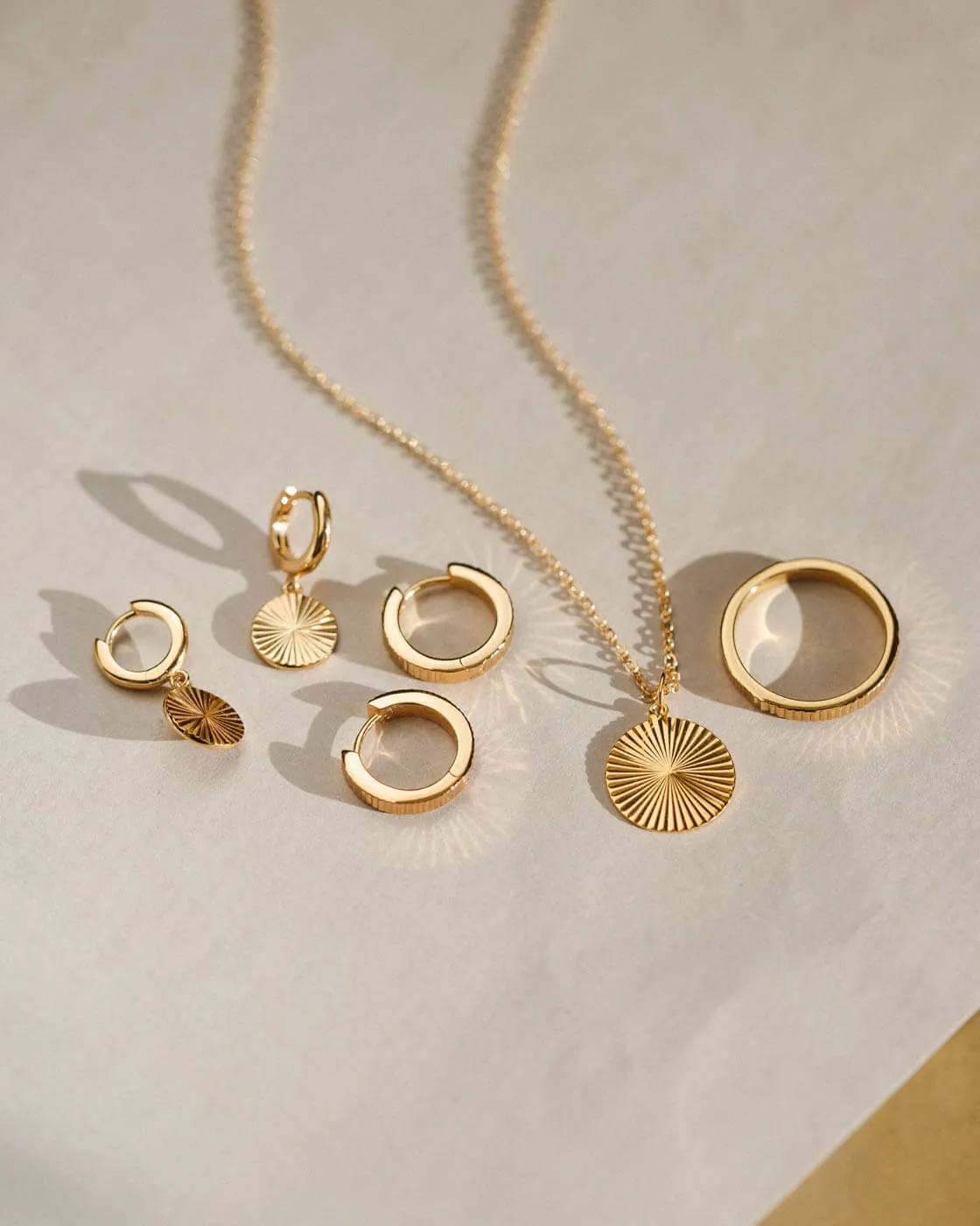 Radiant Charm Huggie Hoops sold by GLDN product image thumbnail 3