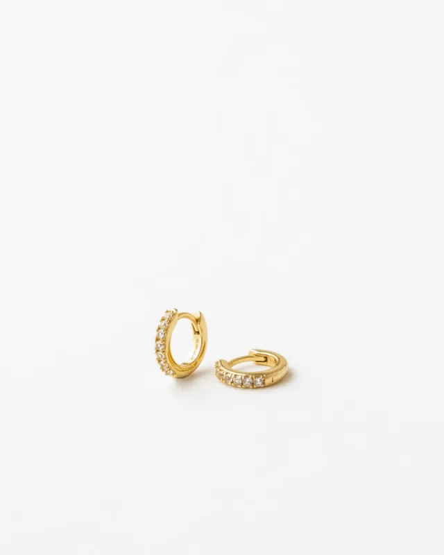 Olivia White Sapphire Huggie Hoops sold by GLDN