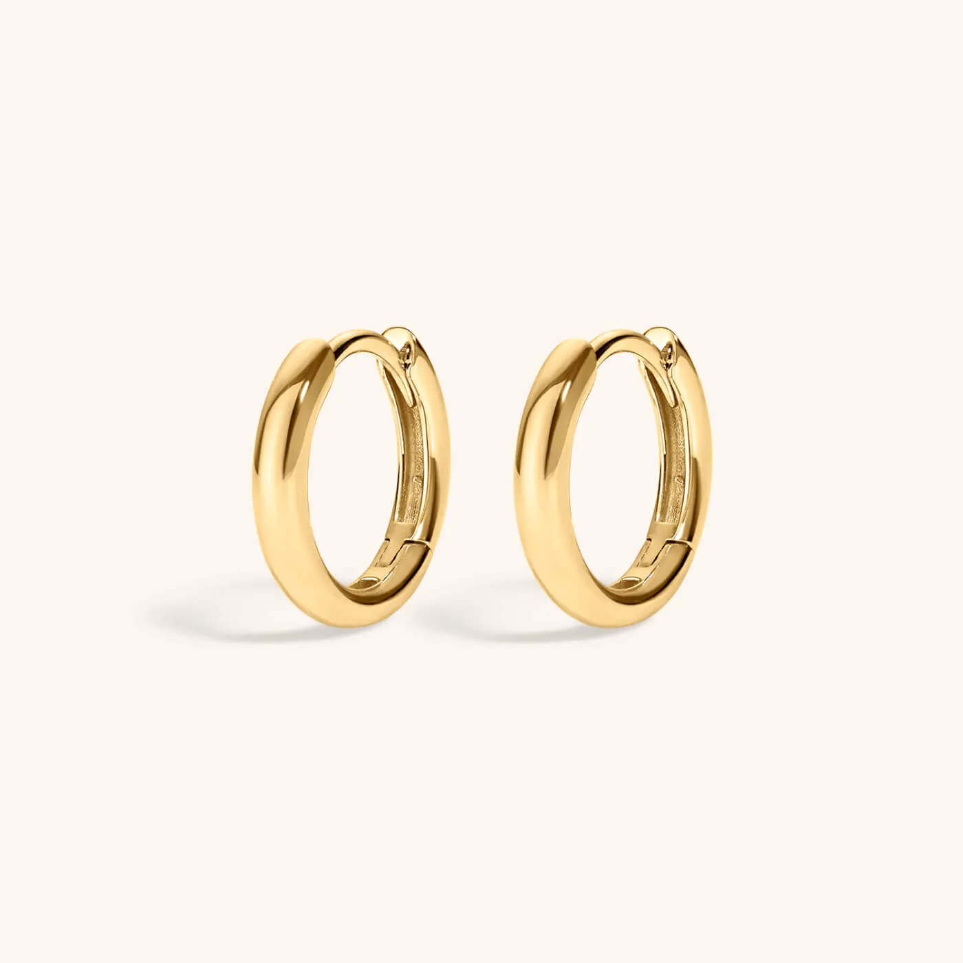 Bold Huggie Hoops in 14k Gold sold by Maison Miru