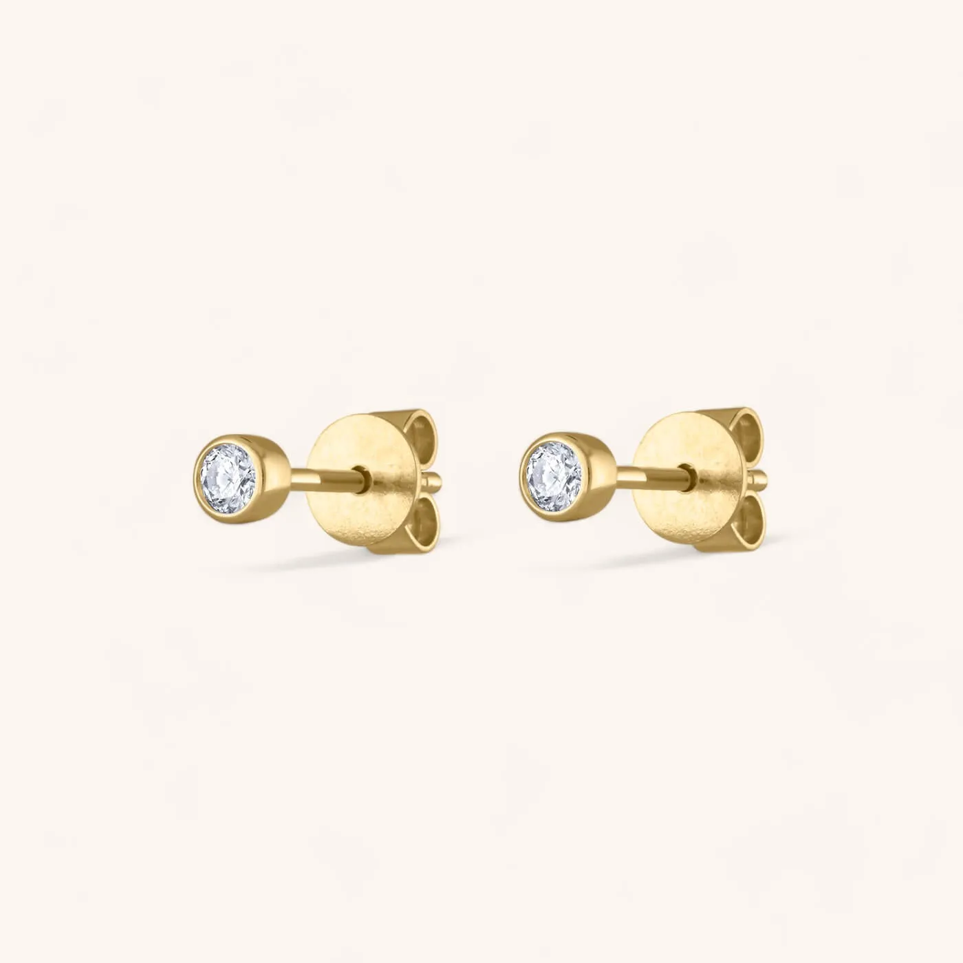Tiny Diamond Studs in 14k Gold sold by Maison Miru