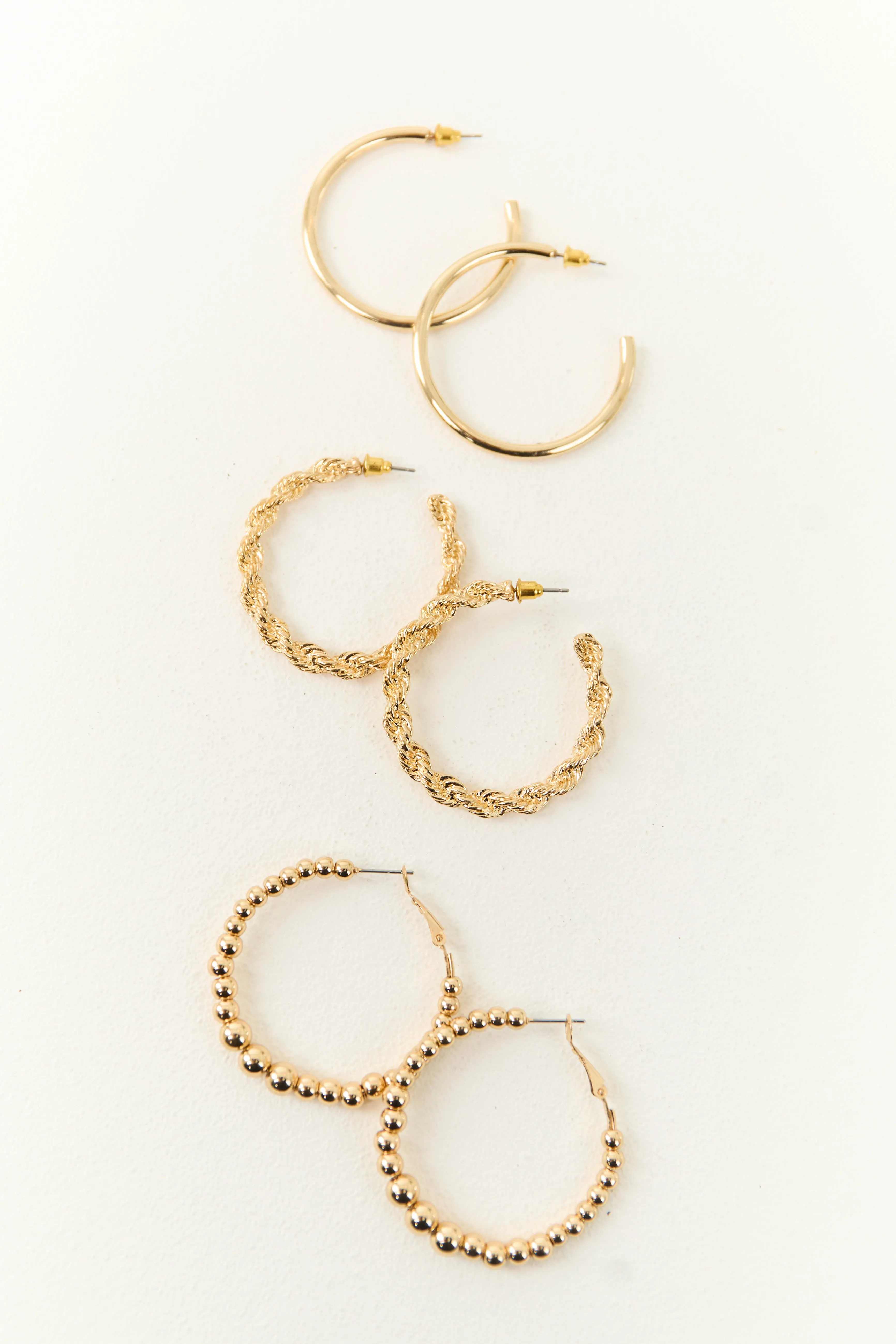 Gold Metallic 3 Piece Textured Hoop Earrings sold by Lime Lush