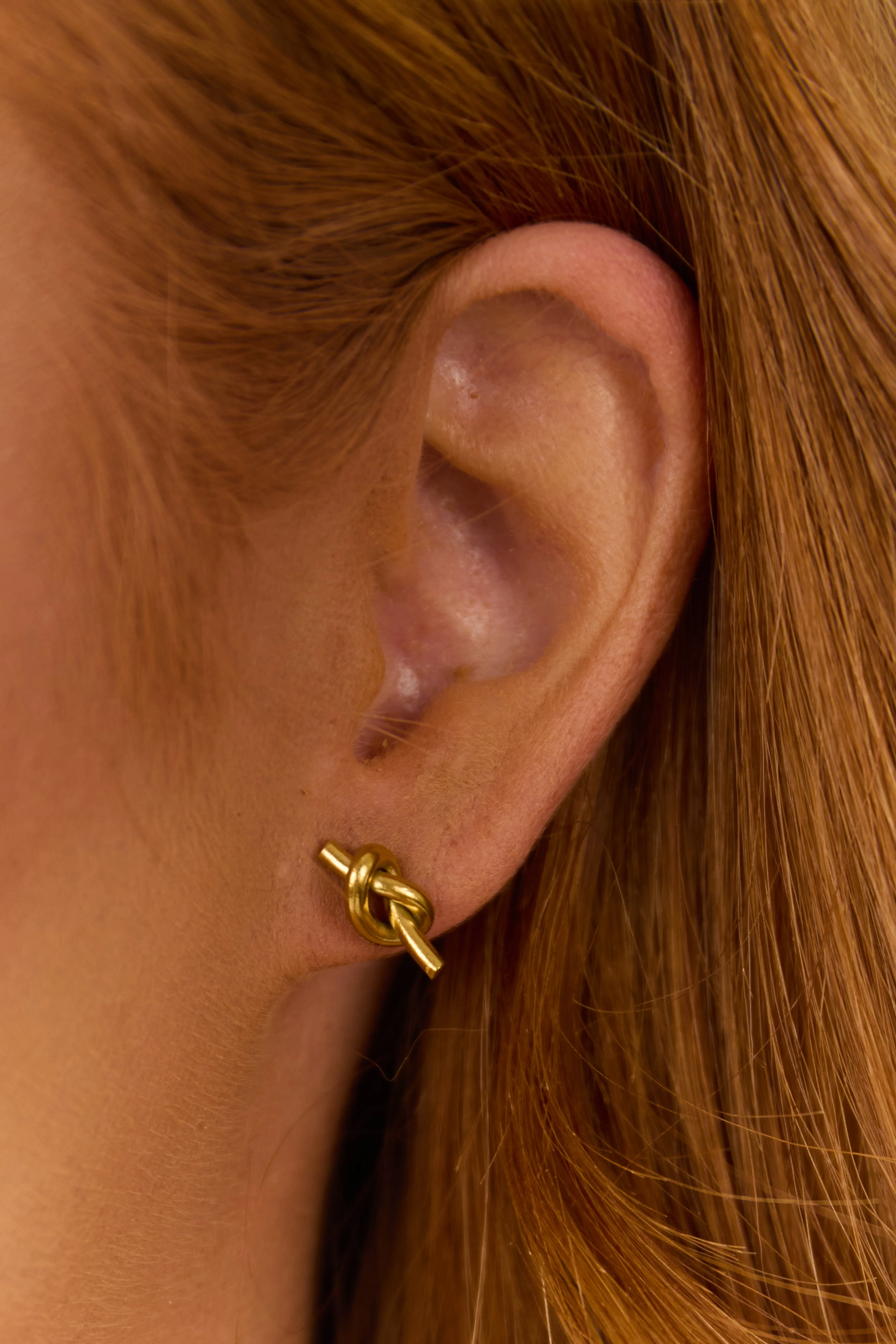Gold Metallic Knot Stud Earrings sold by Lime Lush