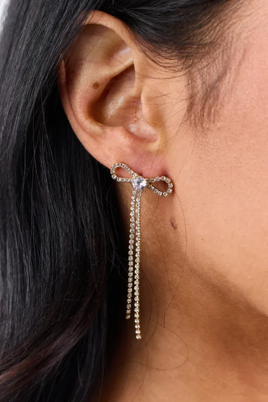 Gold Metallic Clear Rhinestone Bow Dangle Earrings sold by Lime Lush