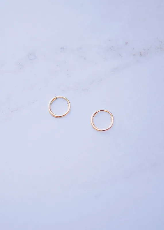 18k Gold Tiny Hoops sold by Ten Wilde