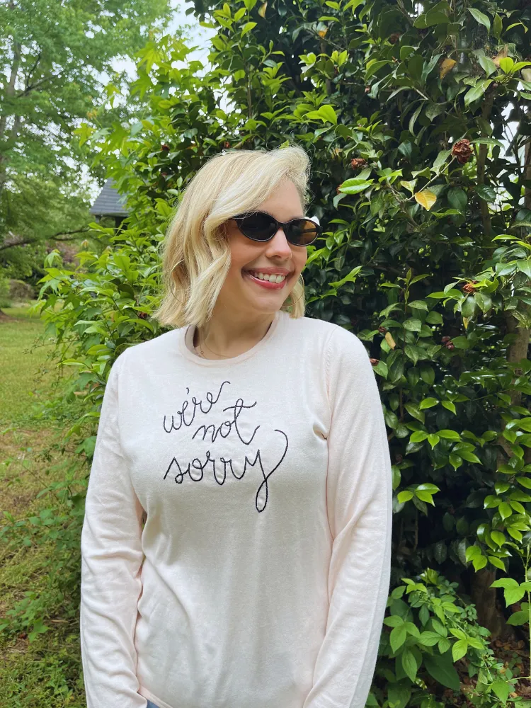 "we're not sorry" Mara Crewneck sold by Lingua Franca NYC