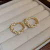 Twisted Gold & Pearl Huggie Hoop Earrings sold by Mason & Madison Co.