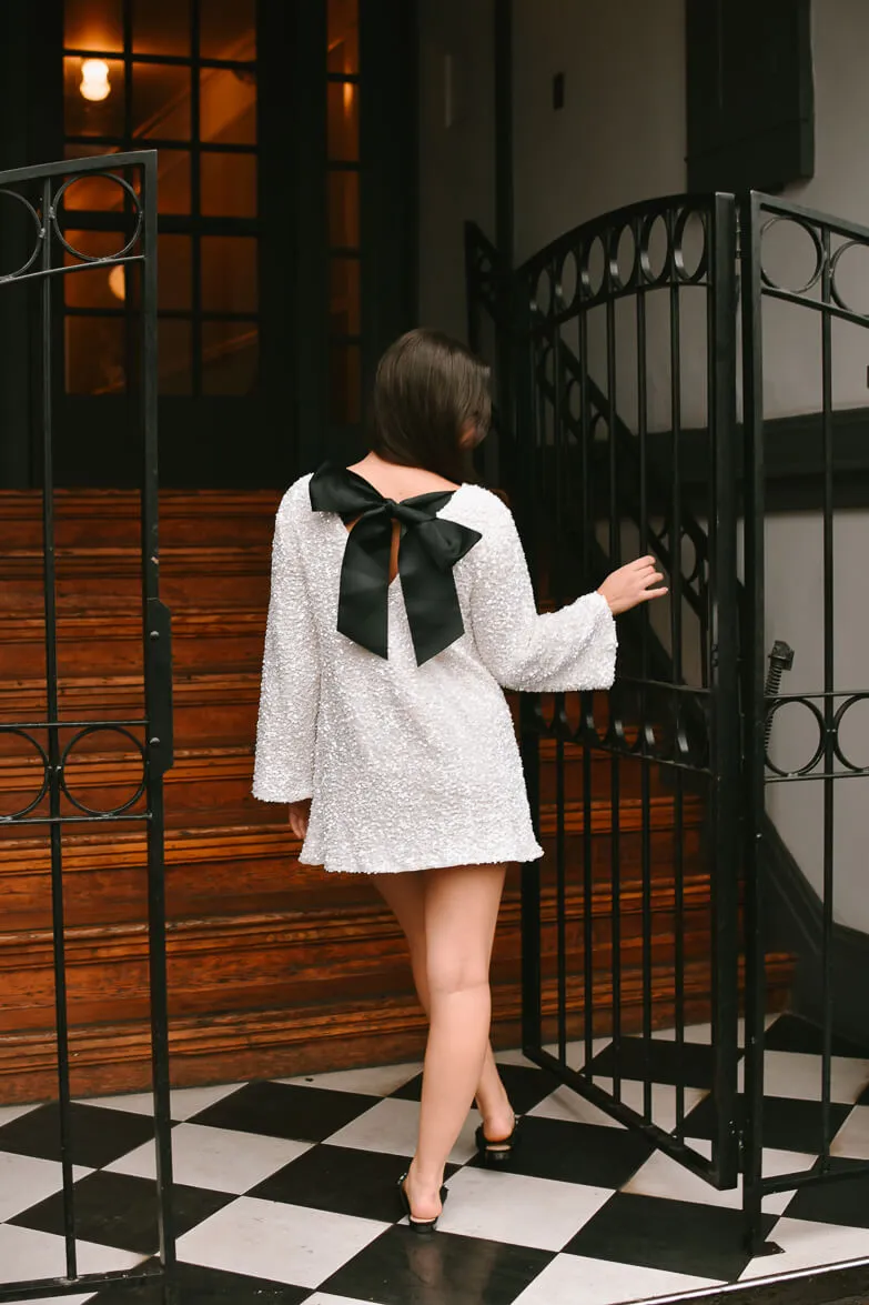 Irina White Sequin Mini Dress with Black Bow sold by Confête