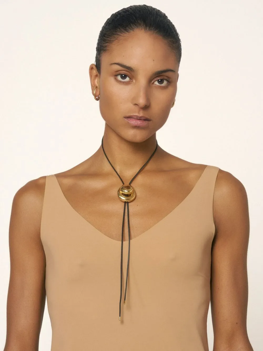 Gold Blow Up Cord Bolo Tie Necklace sold by Fashion Clinic