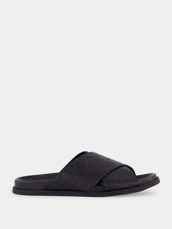Black GG Embossed Leather Slides sold by Fashion Clinic