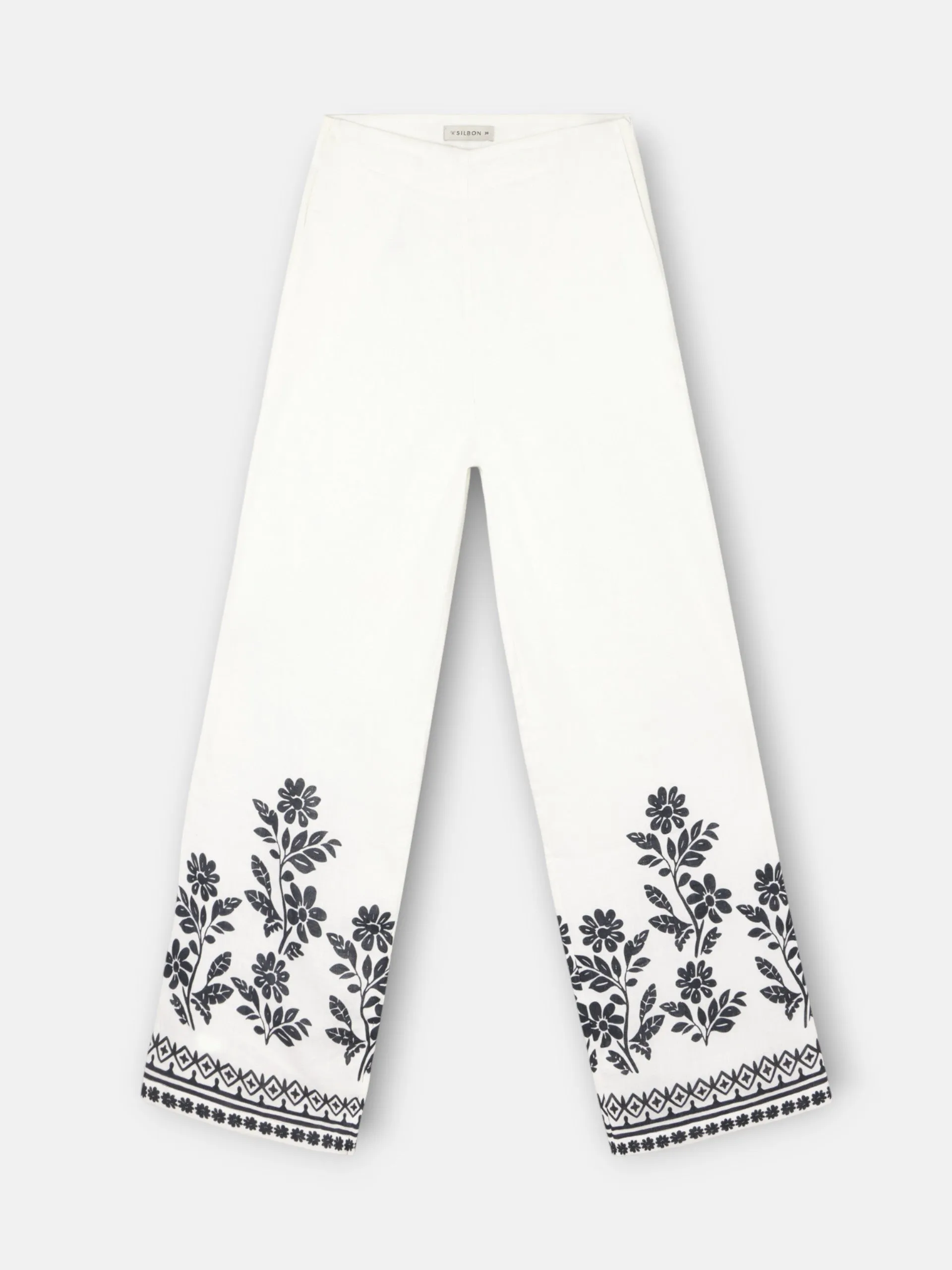 White floral print trousers sold by Silbon