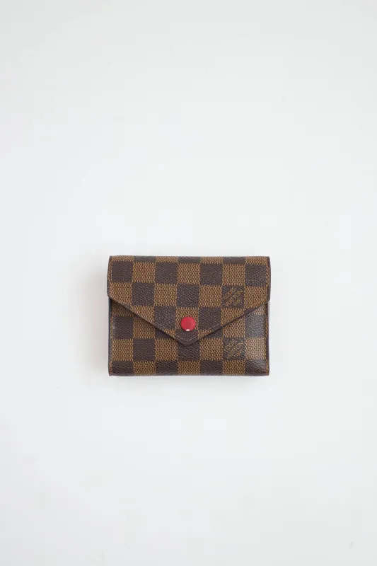 Damier Ebene Victorine Wallet sold by VSP Consignment