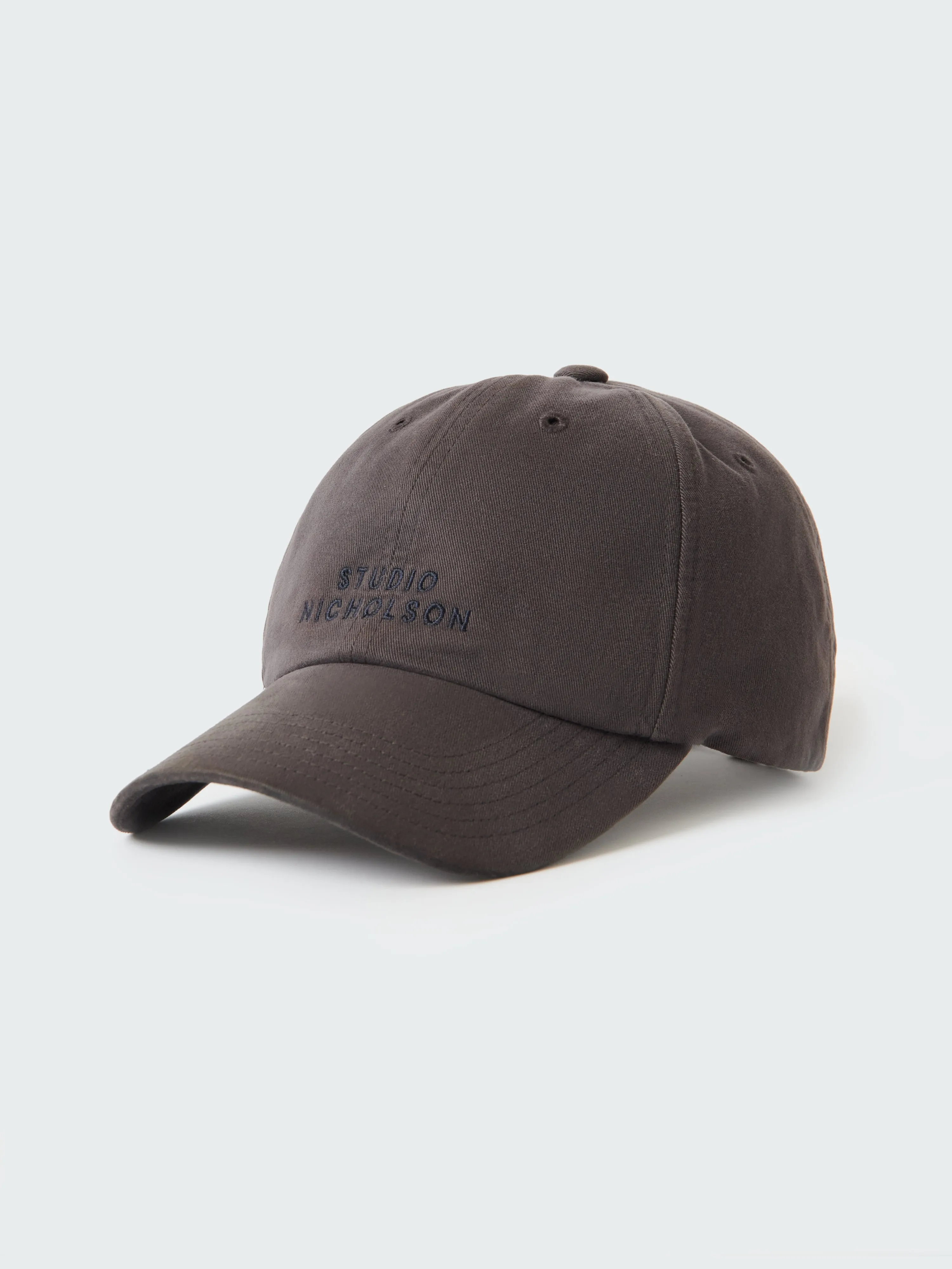 Logo Cap in Asphalt sold by Studio Nicholson