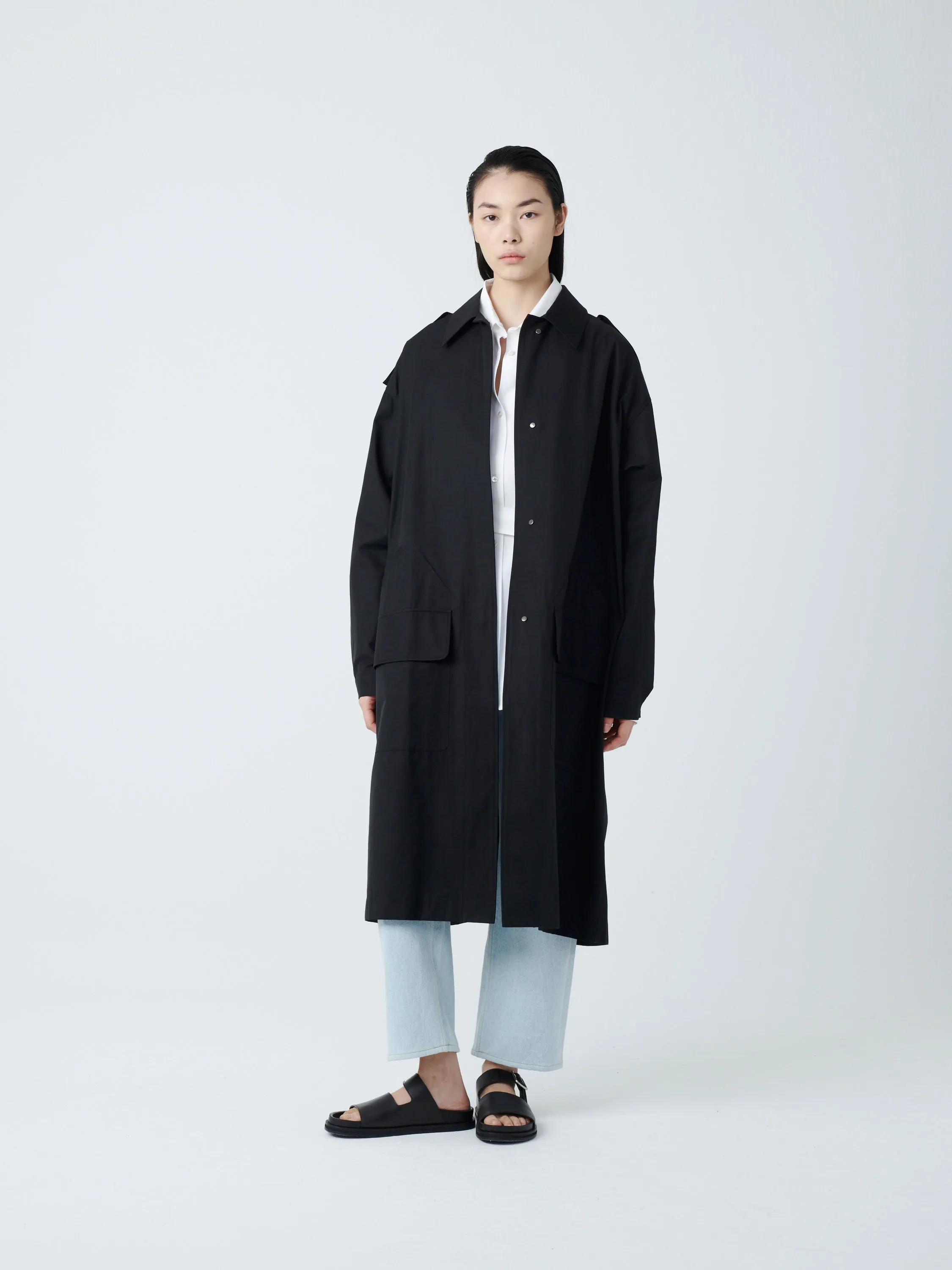 Diphu Coat in Black sold by Studio Nicholson