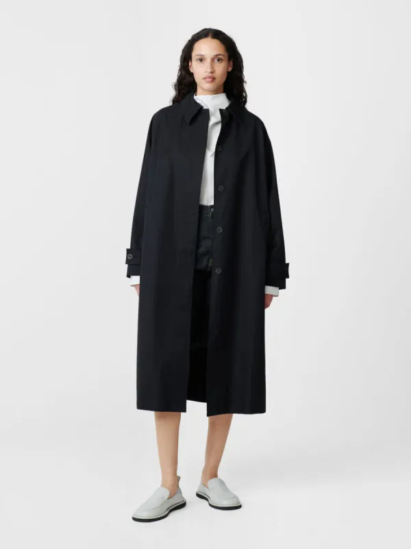 Holin Coated Cotton Coat in Black Grape sold by Studio Nicholson