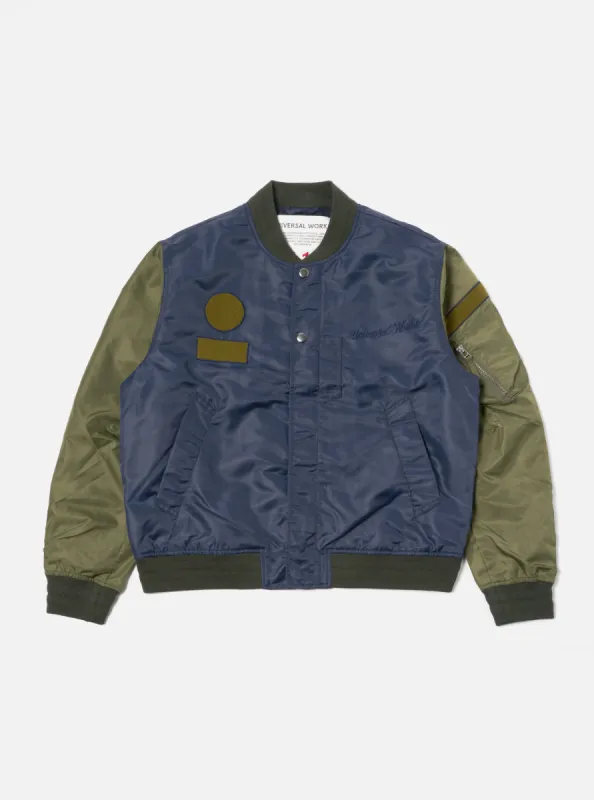 Universal Works Badge Bomber in Olive/Navy Flight Nylon sold by Universal Works