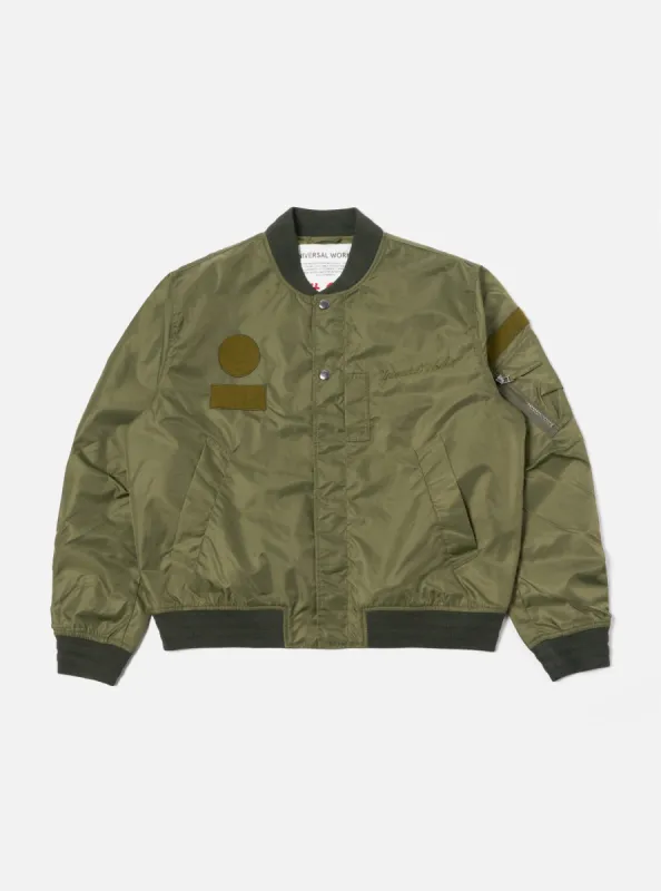 Universal Works Badge Bomber in Olive Flight Nylon sold by Universal Works