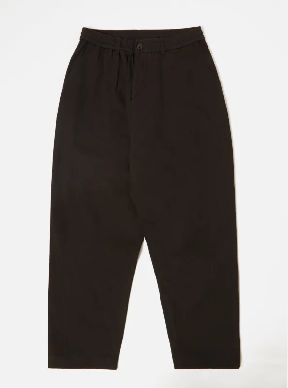 Universal Works Pleated Track Pant in Black Winter Twill sold by Universal Works