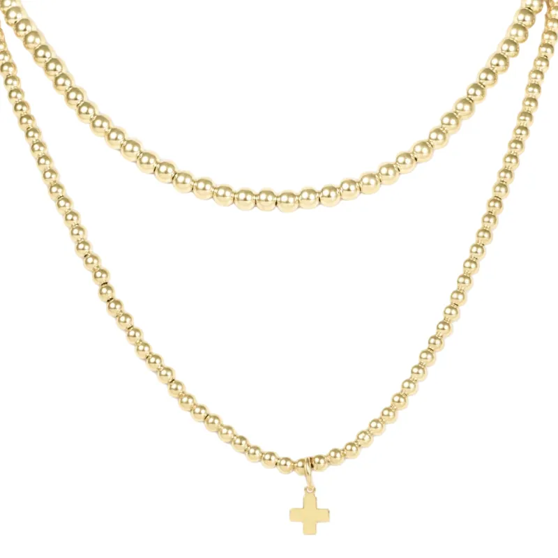 layers with meaning - gold signature cross charm sold by enewton