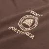 Sporty & Rich Crest Seal 100th T Shirt sold by Asphalt Gold