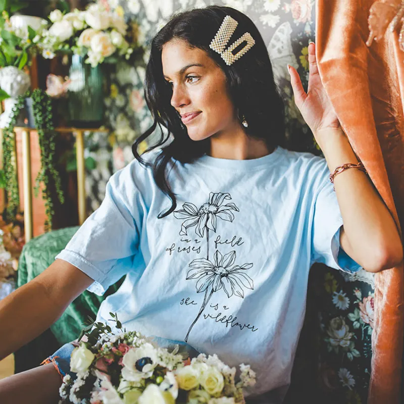 In A Field Of Roses She Is A Wildflower Tee (Wholesale) sold by Alley and Rae