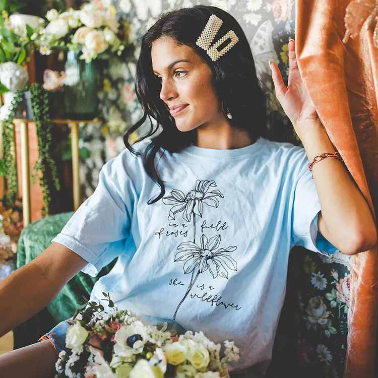 In A Field Of Roses She Is A Wildflower Tee (Wholesale) sold by Alley and Rae