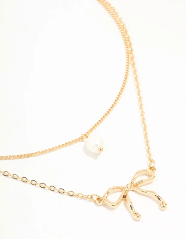 Gold Pearl & Bow Layered Necklace sold by lovisa