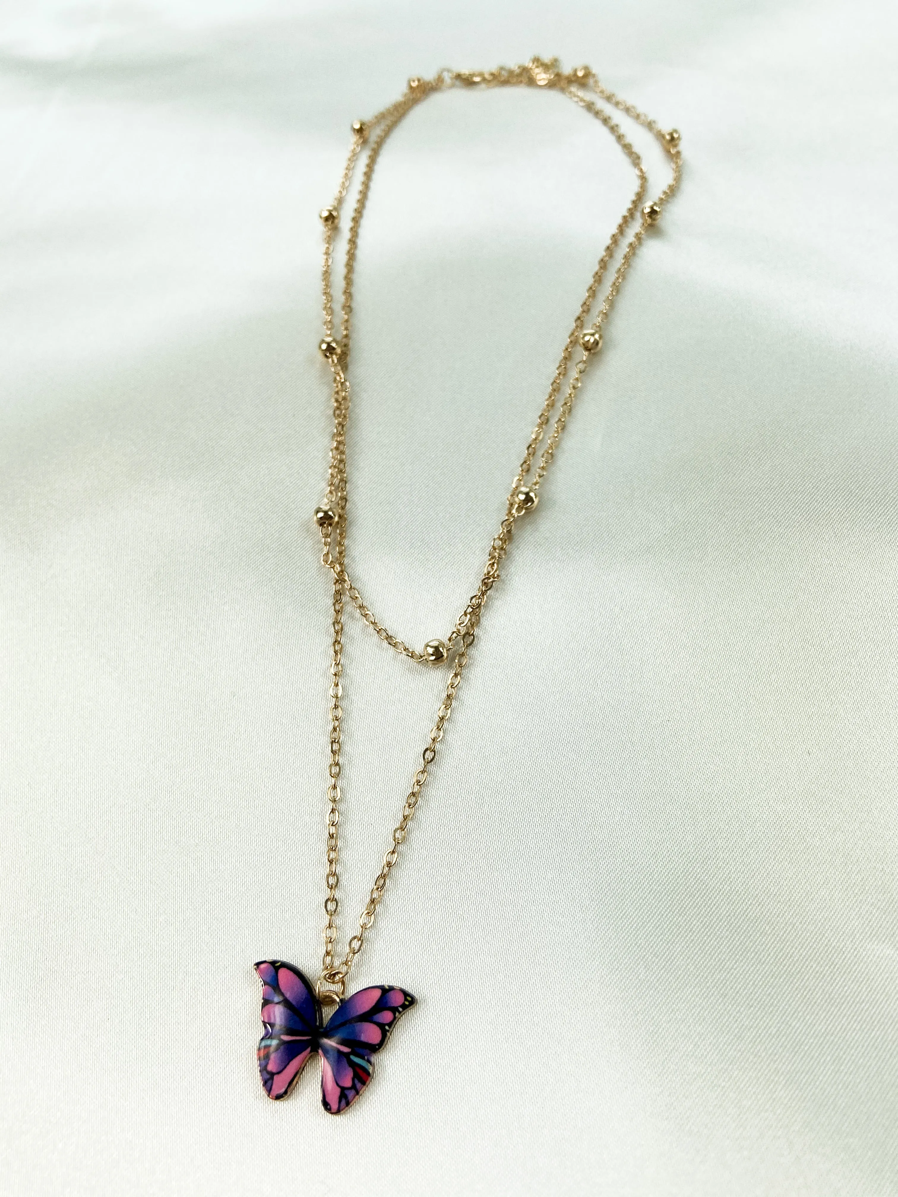 layered butterfly necklace sold by Sunkissed Coconut
